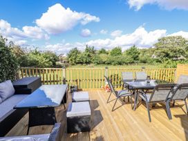 An outdoor seating area with table and chairs at Church View in Withernwick near Aldbrough