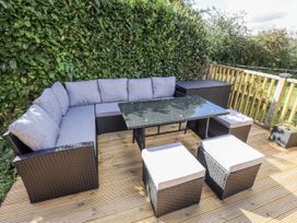 A seating area with a table and cushions at Church View in Withernwick near Aldbrough
