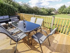 An outdoor dining area with a table and chairs at Church View in Withernwick near Aldbrough