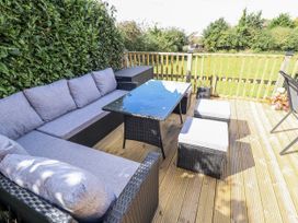 An outdoor seating area with a sofa and table at Church View in Withernwick near Aldbrough