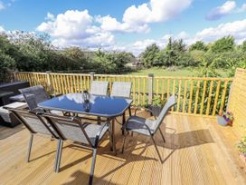 A patio with a table and chairs at Church View in Withernwick near Aldbrough