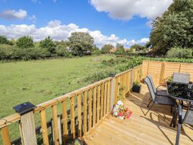 An outdoor space with a table and chairs overlooking a field at Church View in Withernwick near Aldbrough