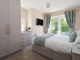 A bedroom with a bed and television at Church View in Withernwick near Aldbrough