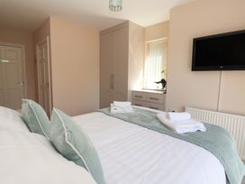 A bedroom with a bed and wardrobe at Church View in Withernwick near Aldbrough