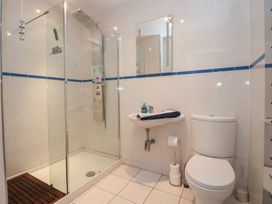 A bathroom with a shower, toilet, and sink at Church View in Withernwick near Aldbrough