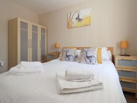 A bedroom with a bed and wardrobe at Church View in Withernwick near Aldbrough