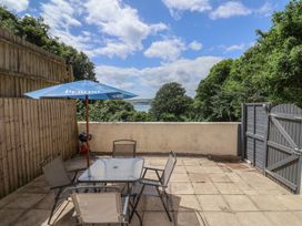 An outdoor patio with a table and chairs at Fairview House in Axmouth