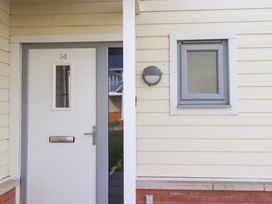 A front door with a mail slot and a small window at The Beach House (Beadnell) Beadnell