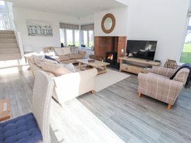 A living room with a sofa and television at The Beach House (Beadnell)