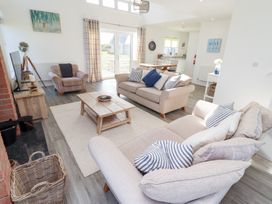 A living room with a sofa and armchair at The Beach House (Beadnell)