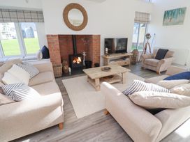 A living room with a fireplace and sofa at The Beach House in Beadnell
