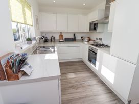 A kitchen with modern appliances and a sink at The Beach House (Beadnell)