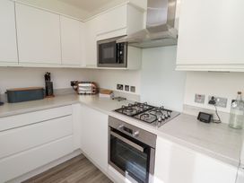 A kitchen with appliances and counters at The Beach House (Beadnell)