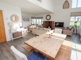 A living room with a table and chairs at The Beach House (Beadnell)