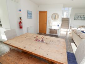 A dining room with a wooden table and chairs at The Beach House (Beadnell) Beadnell