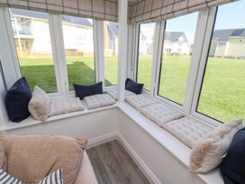 A conservatory with cushions on a bench at The Beach House (Beadnell)