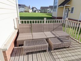 A sofa and coffee table on a deck at The Beach House (Beadnell)