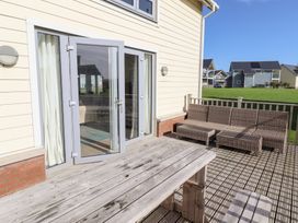 An outdoor seating area with double doors and a sofa at The Beach House (Beadnell) Beadnell