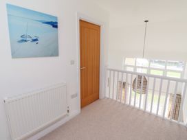 A landing with a painting, door, and radiator at The Beach House (Beadnell)
