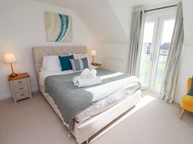 A bedroom with a bed and a nightstand at The Beach House (Beadnell) Beadnell