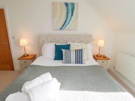 A bedroom with a bed and bedside tables at The Beach House (Beadnell)