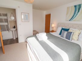 A bedroom with a bed and a sink at The Beach House in Beadnell