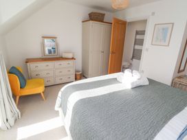 A bedroom with a bed and dresser at The Beach House (Beadnell)