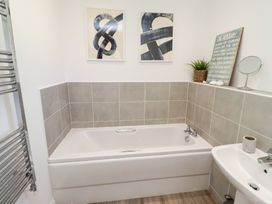 A bathroom with a bathtub and sink at The Beach House (Beadnell)