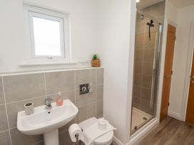 A bathroom with wash basin, toilet, and shower at The Beach House (Beadnell)