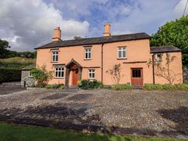 A house with a garden and stone pathway at Hart Head Farm Rydal near Ambleside