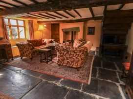 A living room featuring a sofa and armchair at Hart Head Farm in Rydal near Ambleside