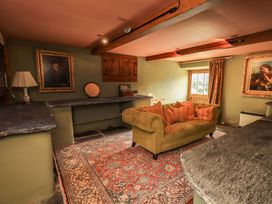 A snug with a sofa and paintings at Hart Head Farm, Rydal near Ambleside