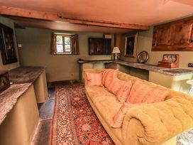 A sitting room with a sofa and a window at Hart Head Farm in Rydal near Ambleside