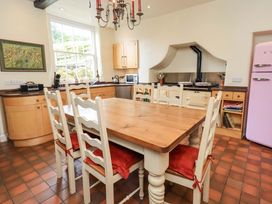 A kitchen with a dining table and chairs at Hart Head Farm in Rydal near Ambleside