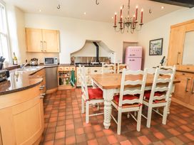 A kitchen with a dining table and chairs at Hart Head Farm Rydal near Ambleside
