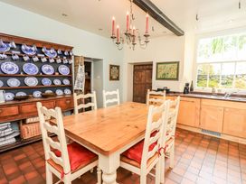 A kitchen with a dining table and chairs at Hart Head Farm in Rydal near Ambleside