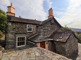 A stone cottage with windows and chimneys at Hart Head Farm Rydal near Ambleside