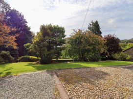A garden with trees and a gravel driveway at Hart Head Farm in Rydal near Ambleside