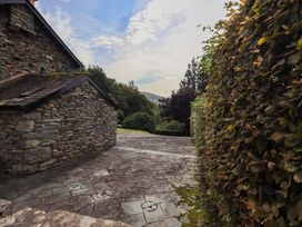 A pathway alongside a stone wall at Hart Head Farm in Rydal near Ambleside