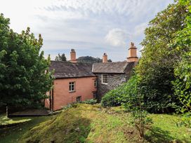 A house with trees and grass at Hart Head Farm in Rydal near Ambleside