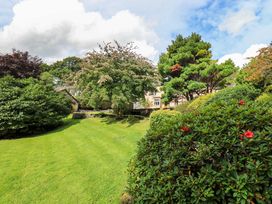 A garden with trees and a house at Hart Head Farm Rydal near Ambleside