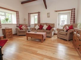A living room with sofas and a coffee table at Bryn Caled in Llanarmon near Y Ffor