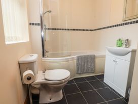 A bathroom with a bathtub and shower at Bryn Caled in Llanarmon near Y Ffor