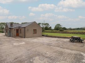 A house with a patio and bench at Bryn Caled Llanarmon near Y Ffor