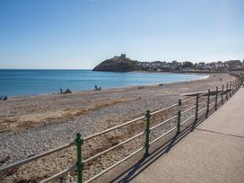 A beach scene with a pathway and fence at Bryn Caled Llanarmon near Y Ffor