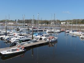 A marina with boats docked and water reflecting at Bryn Caled Llanarmon near Y Ffor