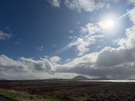 A landscape with clouds and sun in the sky at Geesala
