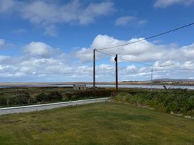 A view of grass and water with power lines at Geesala