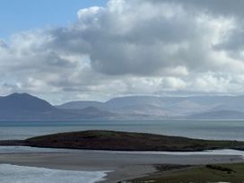 A view of mountains and water with an island at Geesala