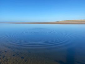 A body of water with ripples and blue sky at Geesala